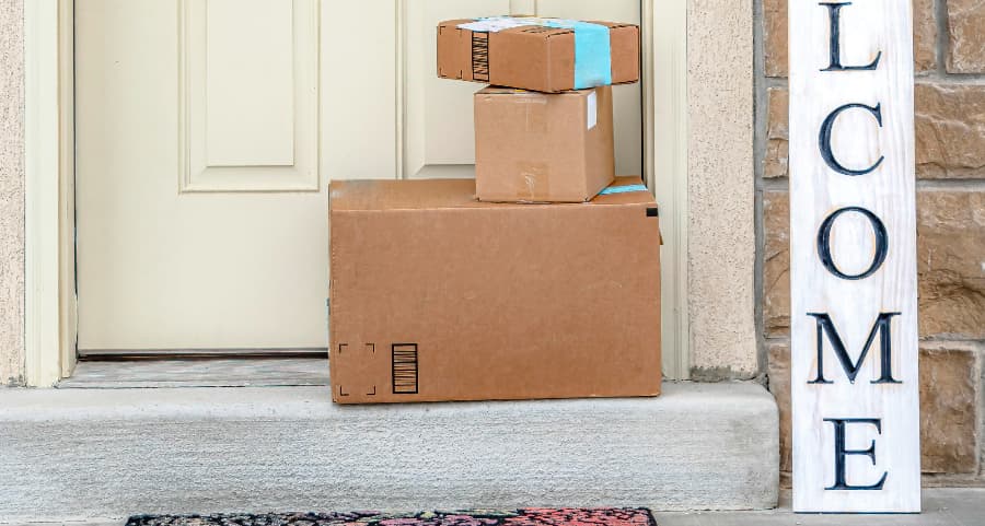 Boxes by the door of a residence with a welcome sign in West Bloomfield